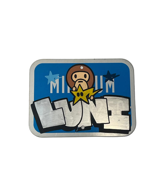 Metallic sign with cartoon character and text on a white background
