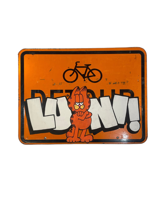 Vintage-style sign with cartoon character and text on an orange background